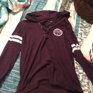 Maroon hoodie with cross design on chest